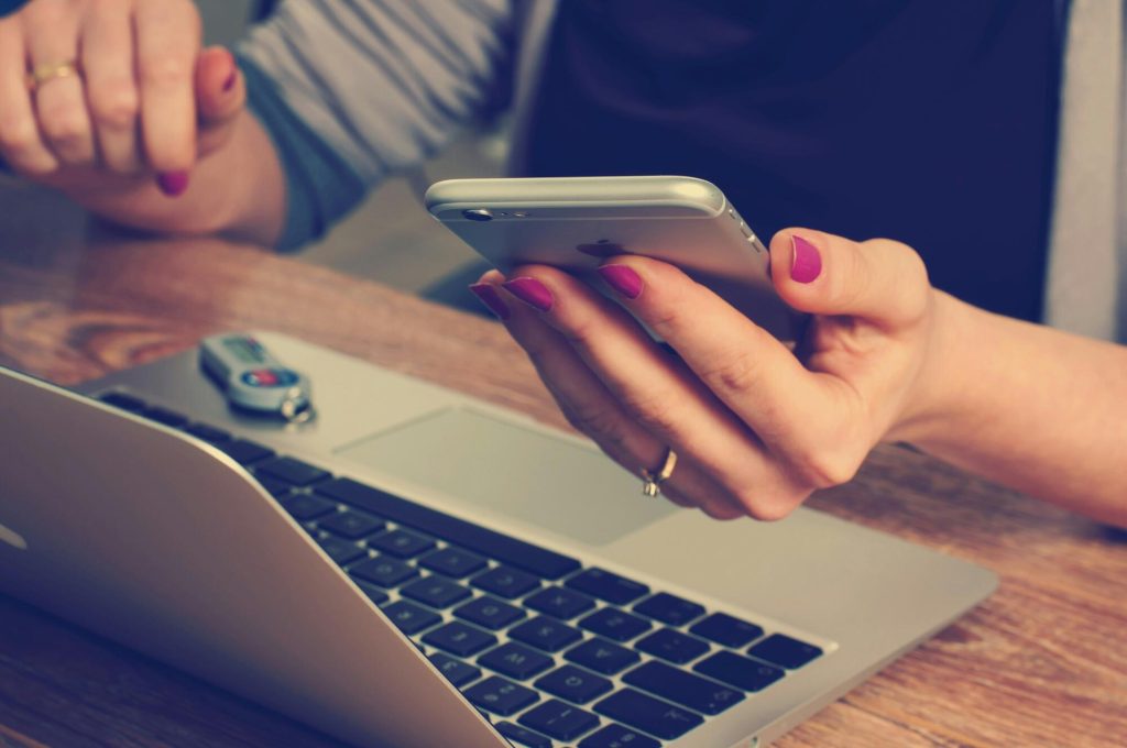 67acbbc1c5f1fceab6212c5a woman holding an iphone